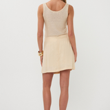 back of woman in neutral outfit 