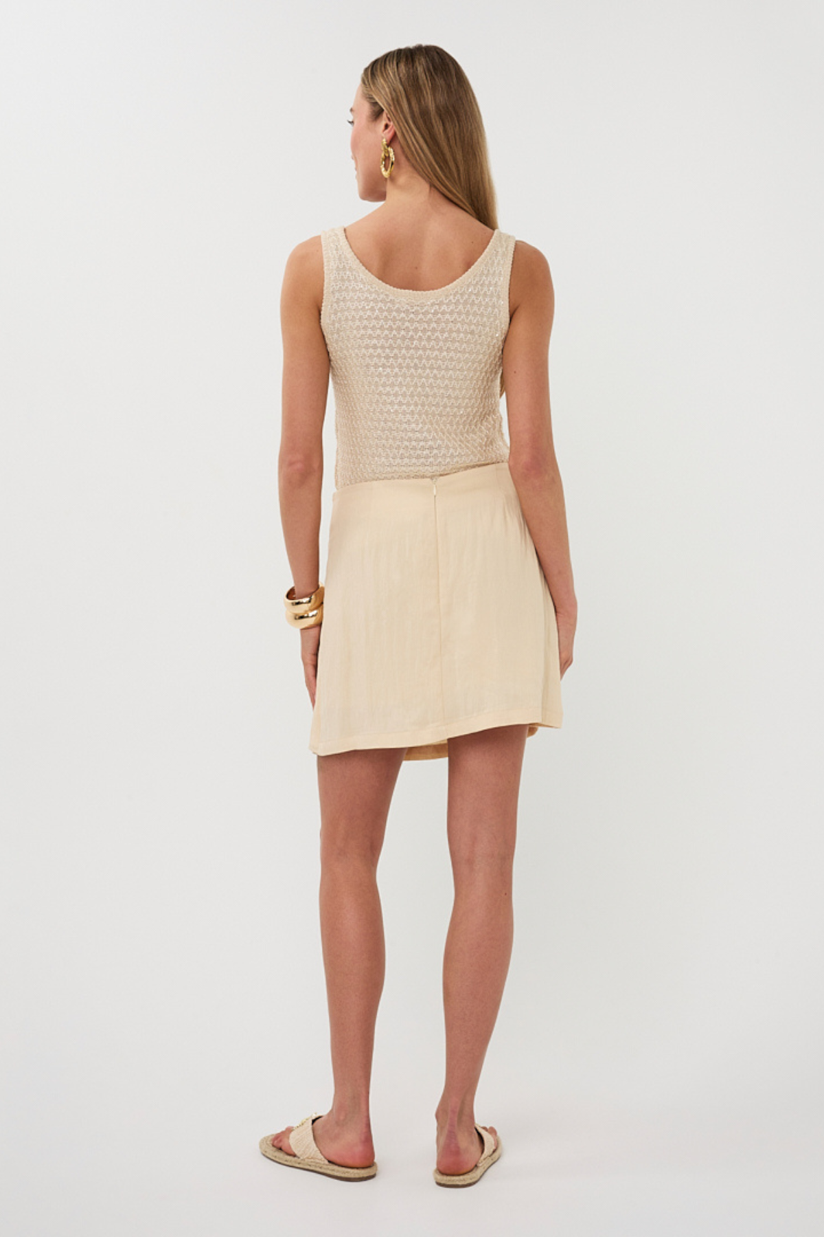 back of woman in neutral outfit 
