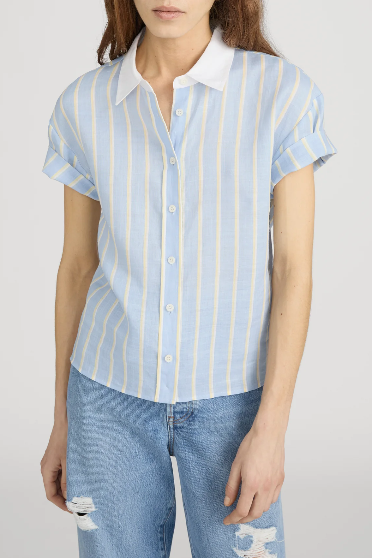 woman in striped button down short sleeve top on white background 