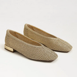 Pair of woven flat shoes on a white background