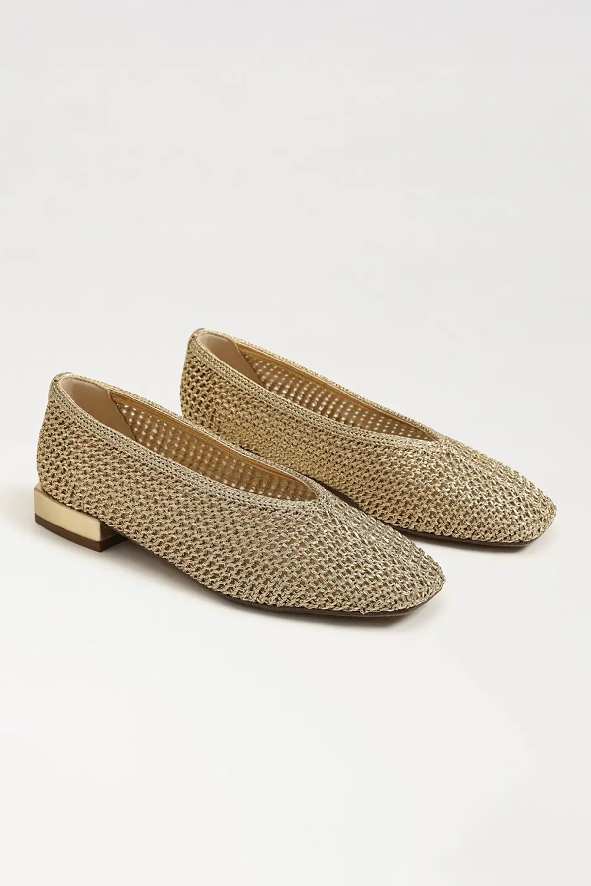 Pair of woven flat shoes on a white background