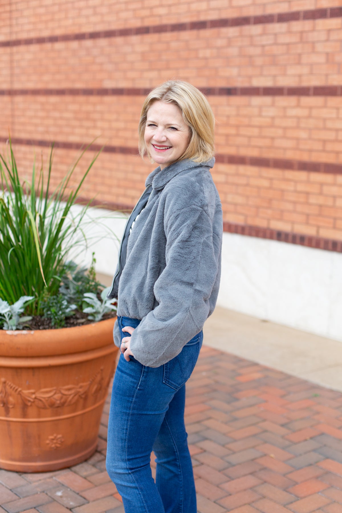 Faux fur zip-up jacket with a plush collar in a neutral tone