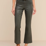 A model wearing dark olive green cropped flare pants with a black belt featuring a gold buckle, paired with a black top and black high heels, against a solid beige background.