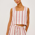 Woman wearing a striped sleeveless top and pants on a white background