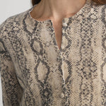 Cashmere cardigan with subtle snake pattern, styled with dark denim