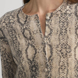 Cashmere cardigan with subtle snake pattern, styled with dark denim