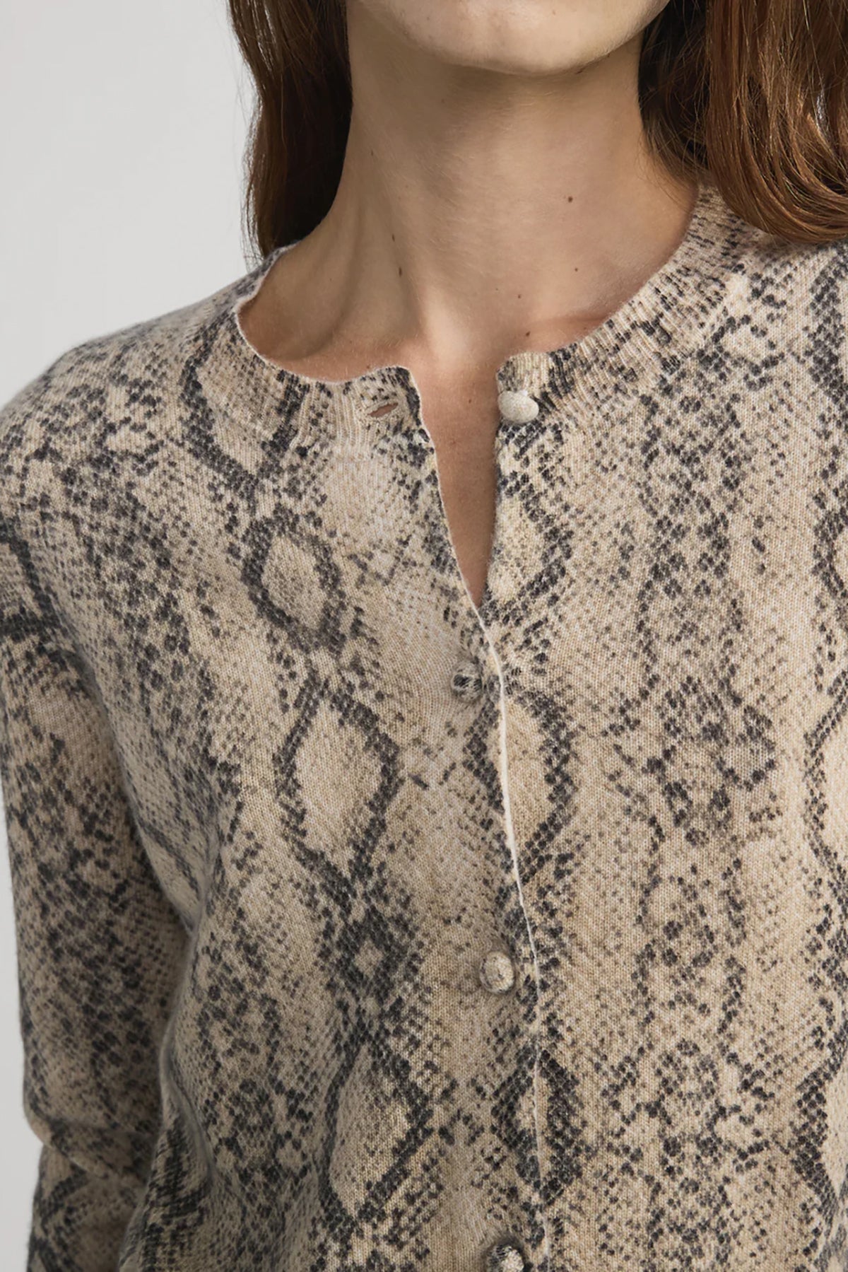 Cashmere cardigan with subtle snake pattern, styled with dark denim