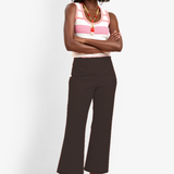 Model wearing slim-fit ankle-length pants styled with a sleeveless top for a polished contemporary look.