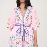 Woman wearing a pink floral robe against a white background