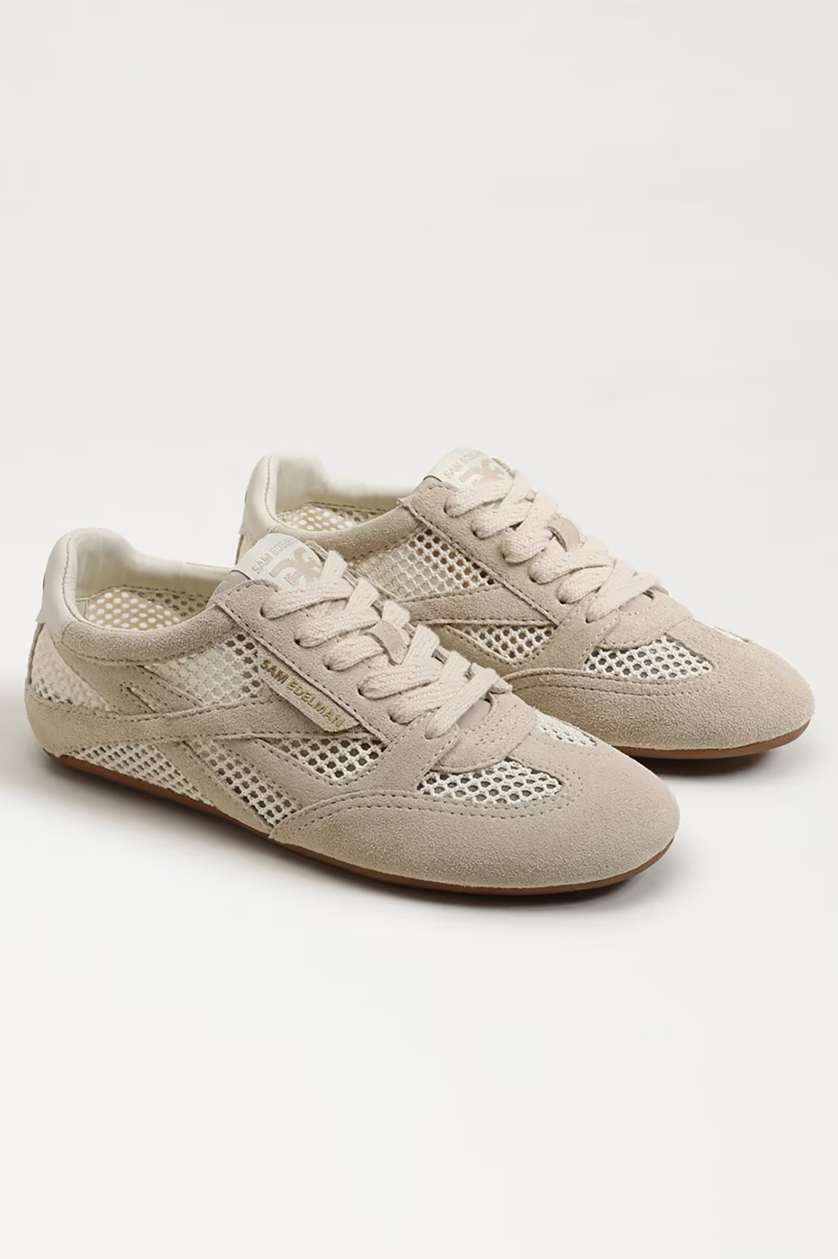 Pair of beige sneakers on a white background