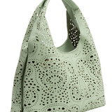 Mint green handbag with perforated design on a white background