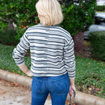 Long sleeve striped sweater with a round neckline.