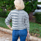 Long sleeve striped sweater with a round neckline.