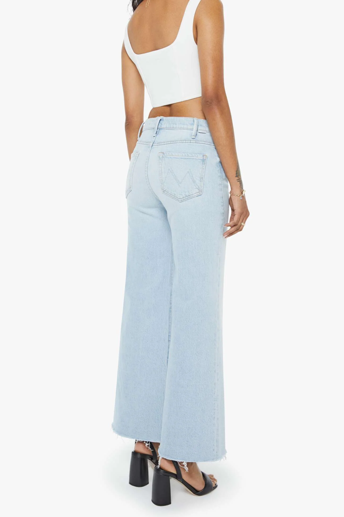 Light blue wide-leg jeans worn by a person on a white background