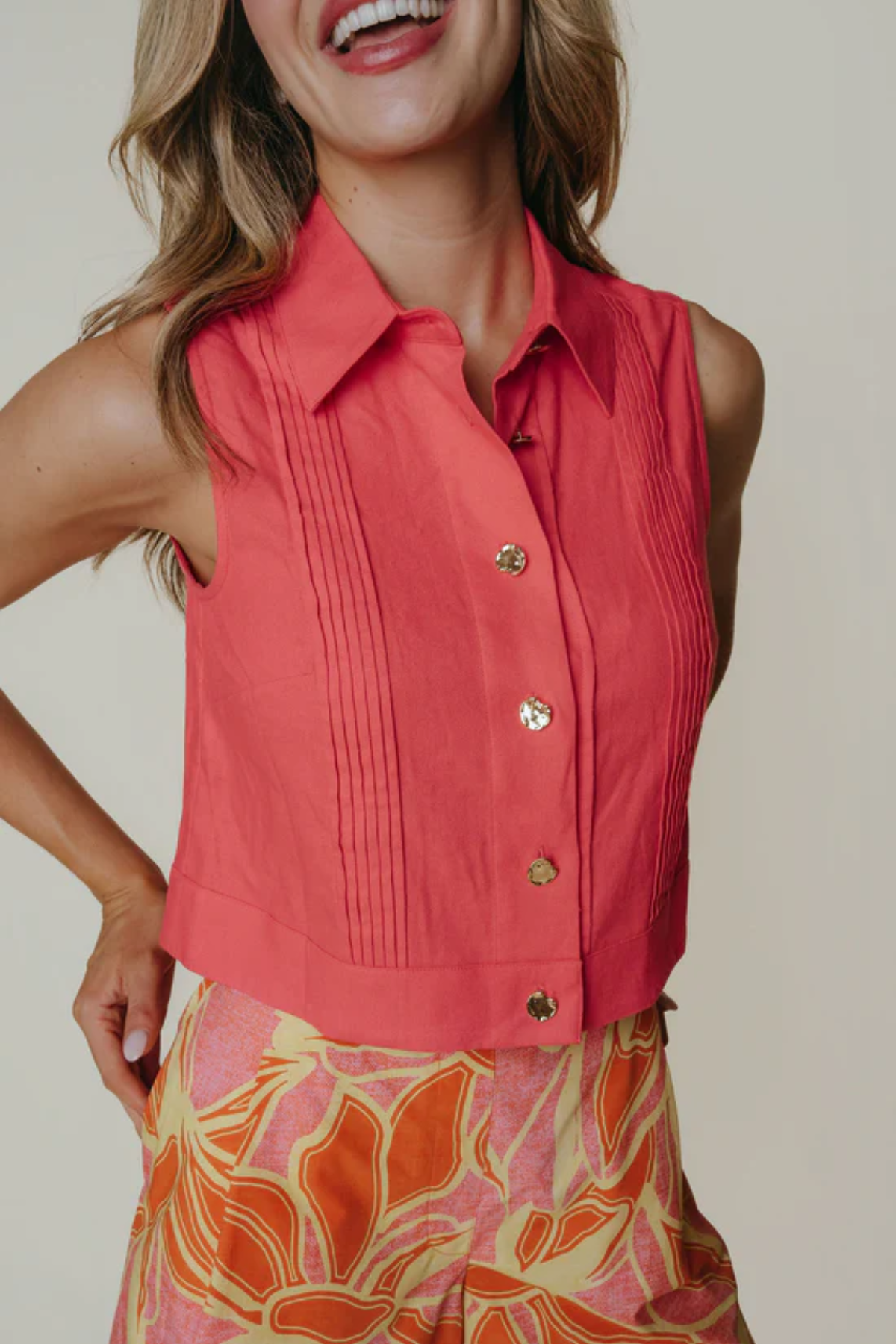 woman in red top on tan background 