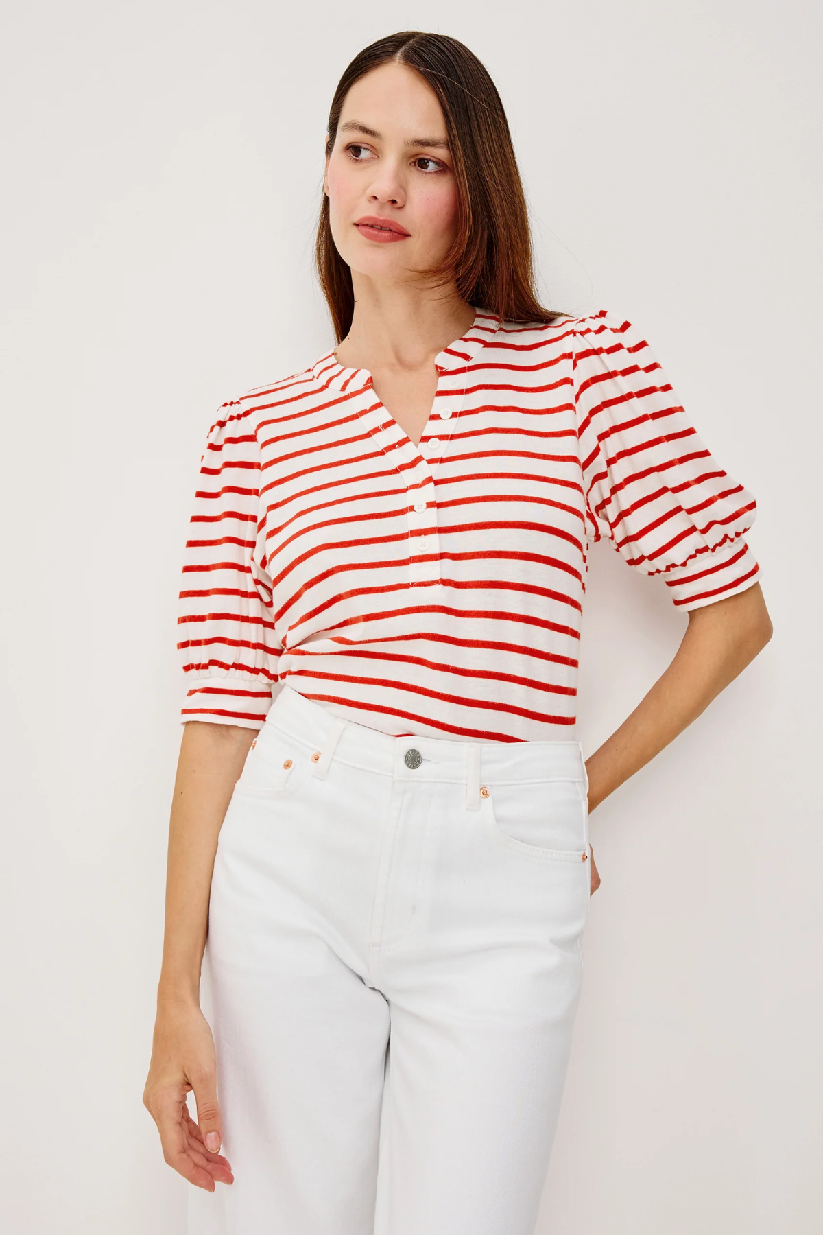 woman in white and red stripe top on white background 