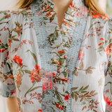 Close-up of a floral blouse with a blurred background
