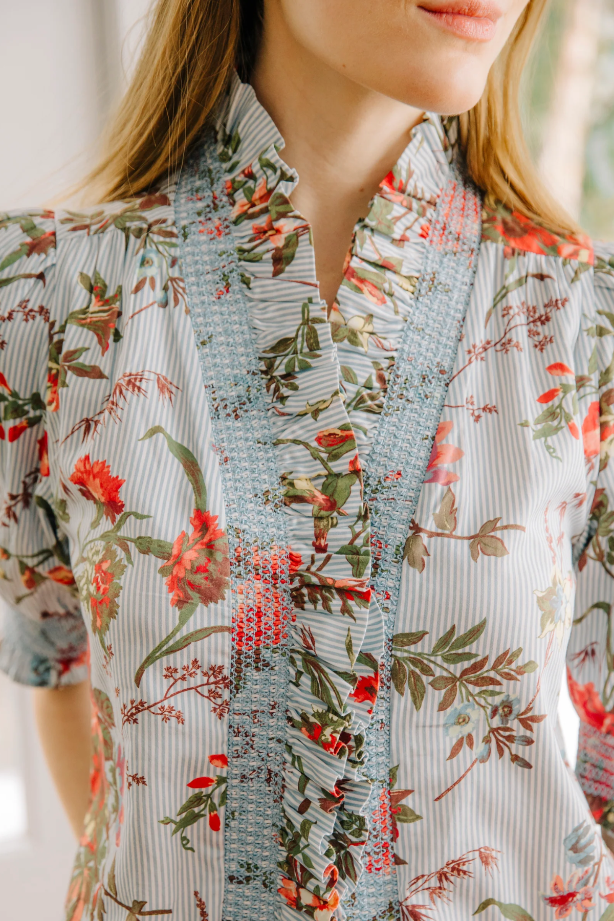 Close-up of a floral blouse with a blurred background