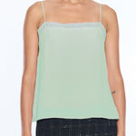 woman in mint green tank top on white background 