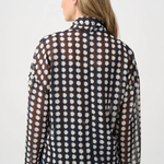 Model wearing a long-sleeve chiffon blouse with a geometric print and tie-neck detail in a relaxed, feminine silhouette.