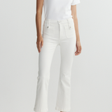 Person wearing a white t-shirt and white pants on a light gray background