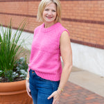 Sleeveless crew neck knit sweater styled with neutral bottoms.