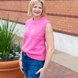Sleeveless crew neck knit sweater styled with neutral bottoms.