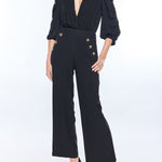 woman in black top and black pants on white background 