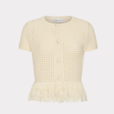 A short-sleeve cream-colored knit cardigan featuring a textured openwork pattern, button front, and a fringed hem, displayed against a light gray background.