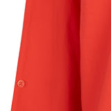 Close-up of a red garment with a button on a white background