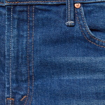 Close-up of blue denim fabric with stitching details
