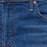 Close-up of blue denim fabric with stitching details