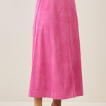 Person wearing a bright pink skirt on a plain background