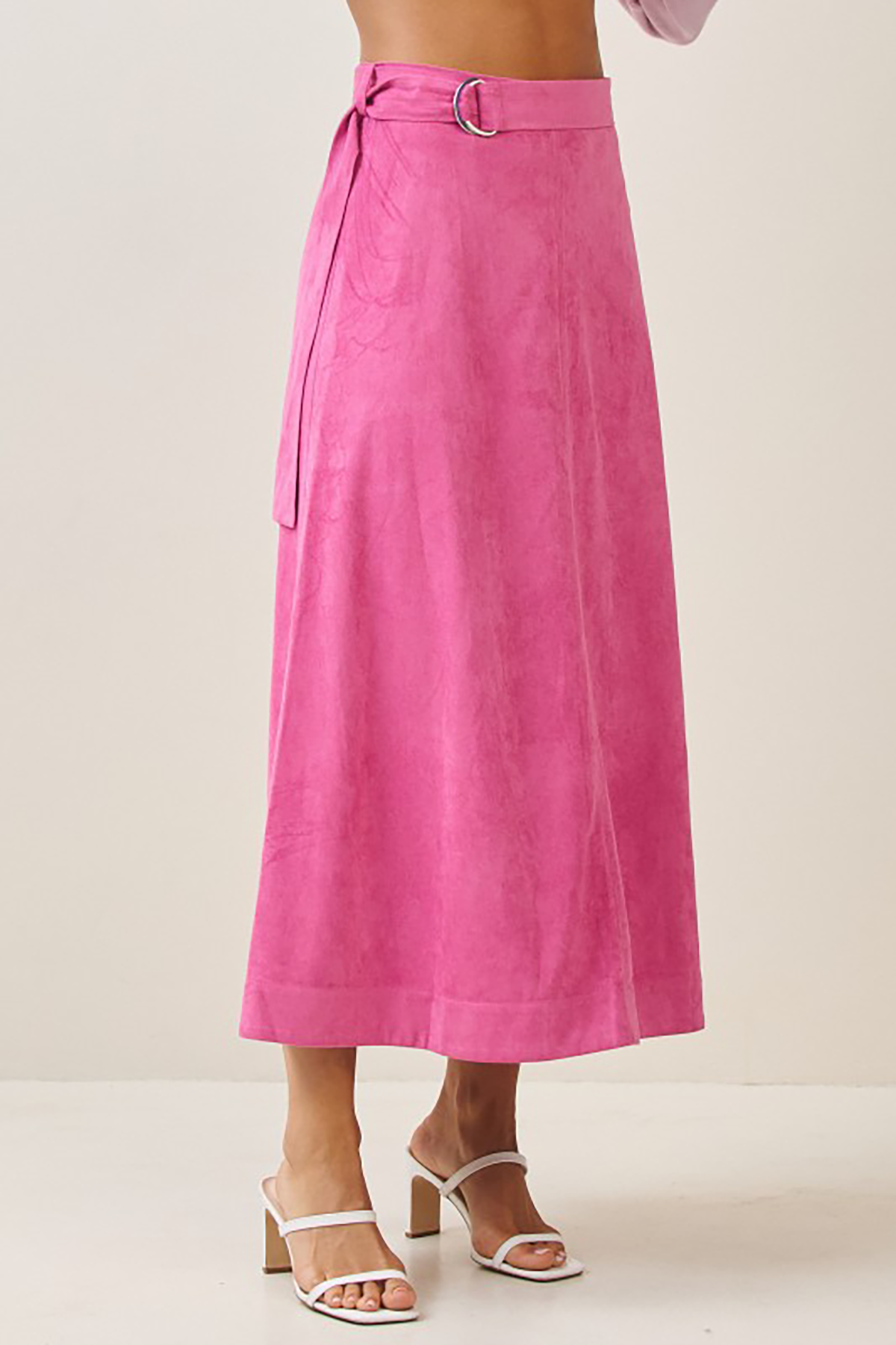 Person wearing a bright pink skirt on a plain background