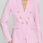 woman in pink blazer on white background 