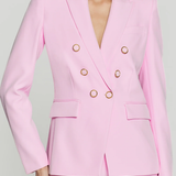 woman in pink blazer on white background 