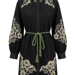 A black long-sleeve shirt dress with intricate cream-colored floral embroidery on the shoulders, sleeves, and hem, featuring a green rope tie belt at the waist.