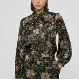 Women's printed style featuring an earthy multicolor pattern and feminine silhouette.
