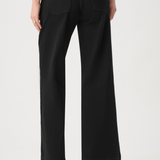 Model wearing dark-wash wide-leg jeans with sailor-inspired button detailing at the waist.