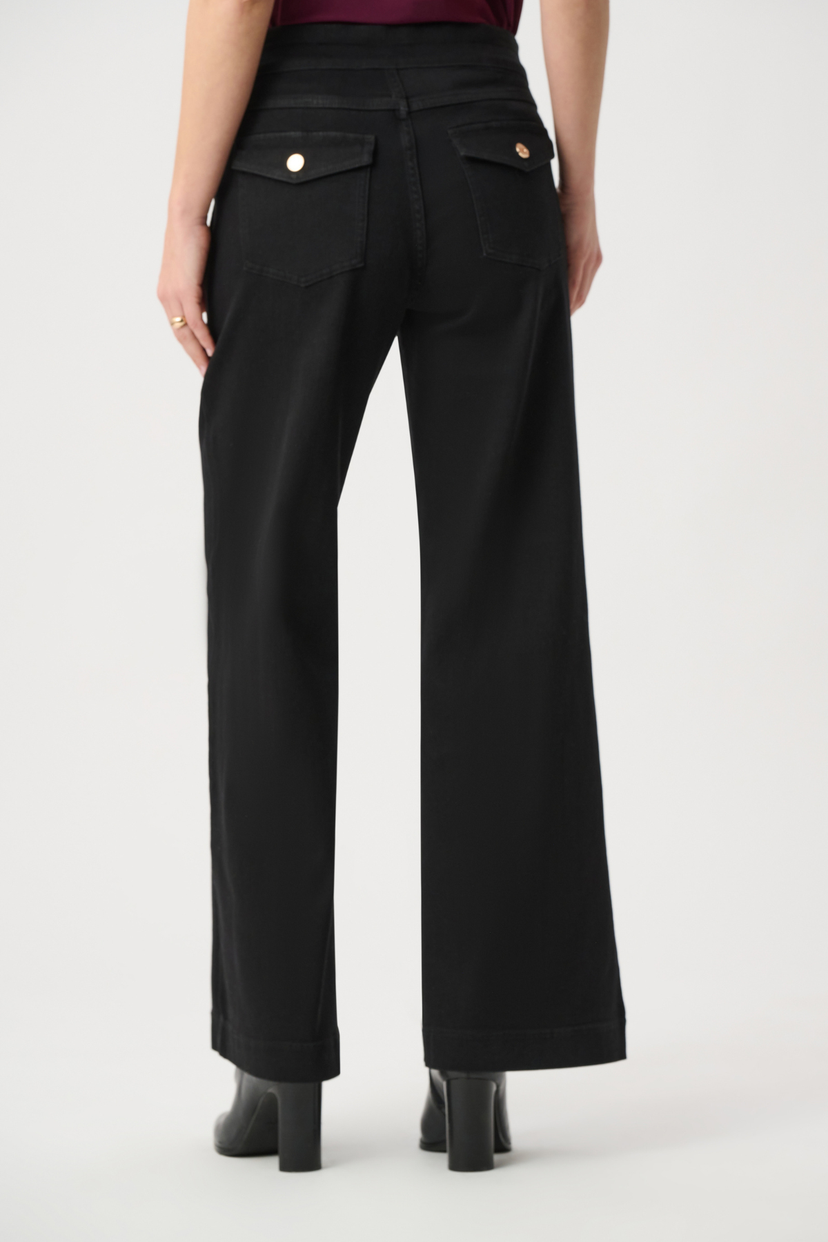 Model wearing dark-wash wide-leg jeans with sailor-inspired button detailing at the waist.