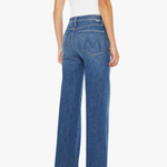 Woman wearing blue jeans and a white top on a white background