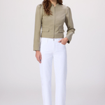 Woman wearing a green jacket and white pants on a white background