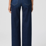 Person wearing dark blue jeans on a white background