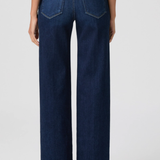 Person wearing dark blue jeans on a white background