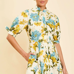 Woman wearing a floral dress with a plain background
