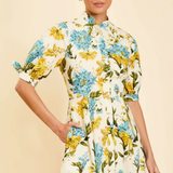 Woman wearing a floral dress with a plain background