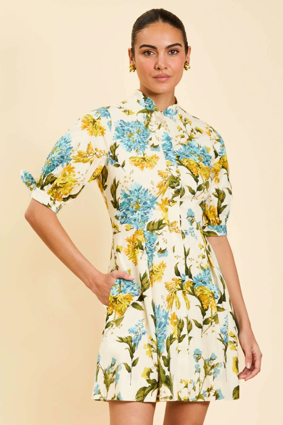 Woman wearing a floral dress with a plain background