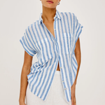 Woman wearing a blue and white striped shirt on a plain background