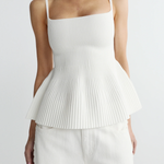 woman in ribbed peplum tank top on white background 