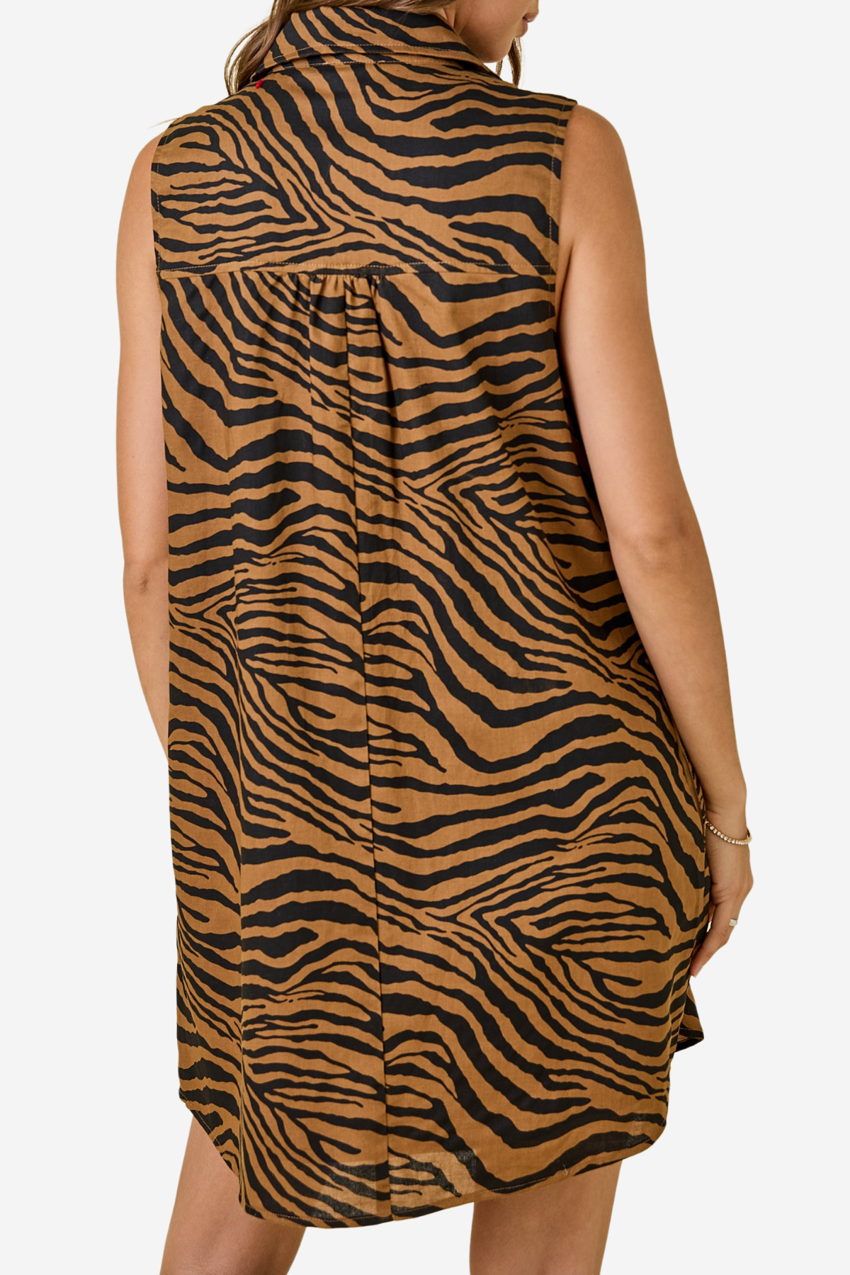 A sleeveless high-neck tunic dress with a brown and black zebra print, shown from the back on a model against a light gray background.